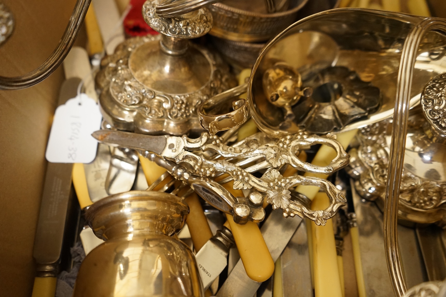 A group of sundry plated items including dwarf candelabra, a pair of wine coasters, a pair of grape shears, etc., and a quantity of assorted ivorine handled table and dessert knives.